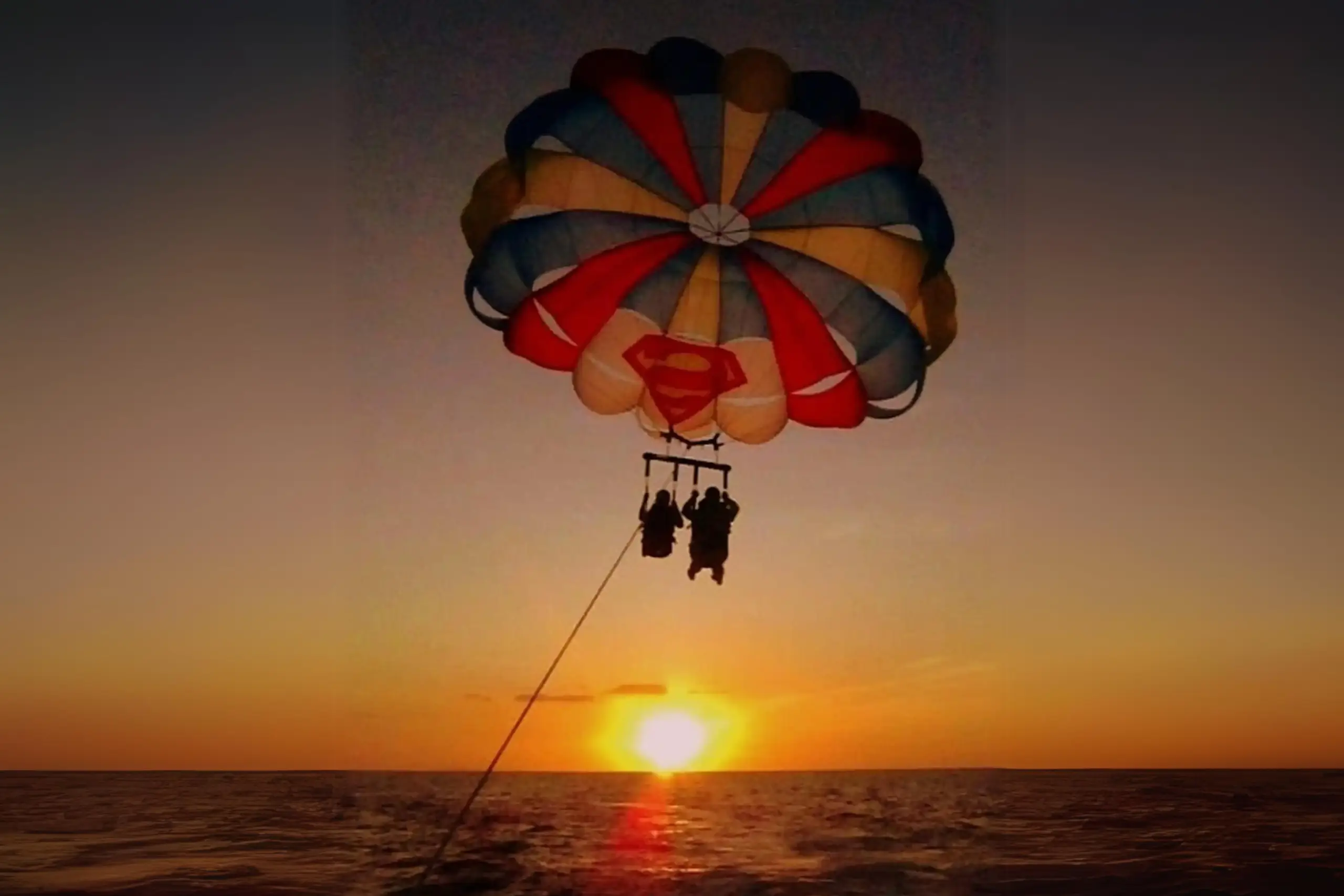 Two tourist enjoying Parasailing activity