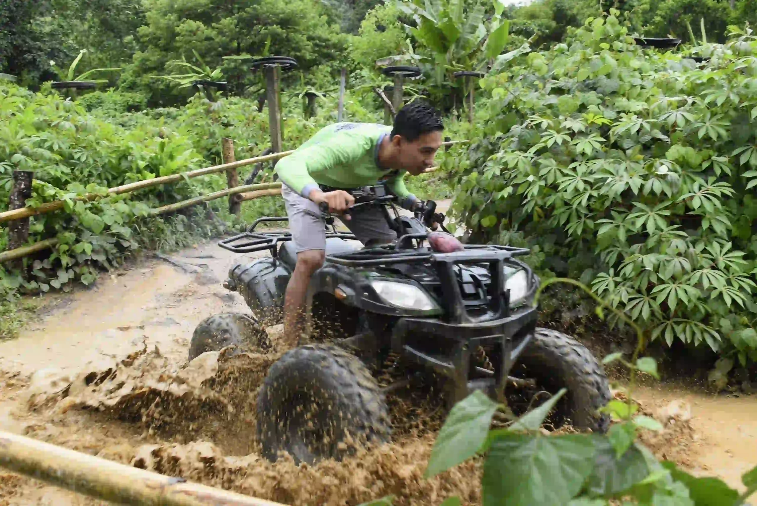 tourist riding an ATV on a muddy track