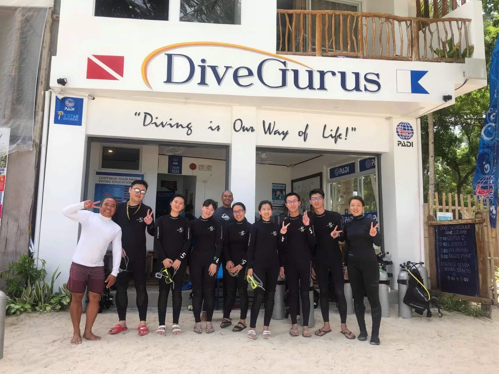 Dive instructor and guests posed for a photo outside the Dive Gurus Resort
