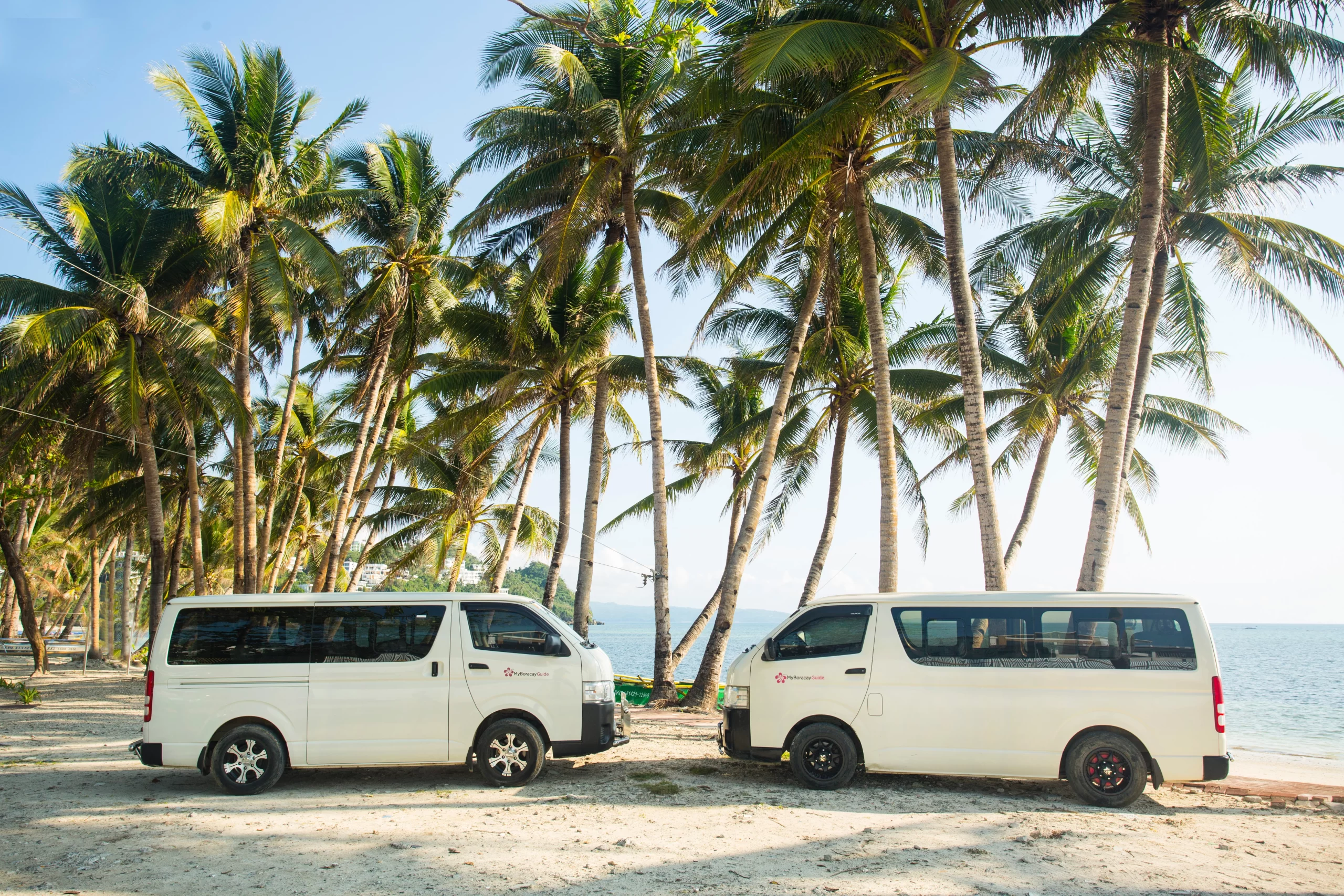 MyBoracayGuide Vans with coconut trees and sea at the back