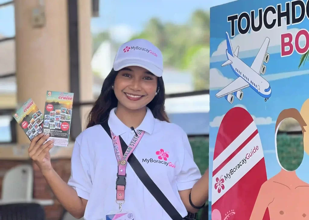 an OJT of MyBoracayGuide poses for a photo with maps