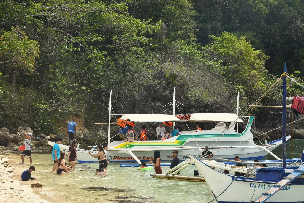 Tourists drop by Ilig Iligan Beach