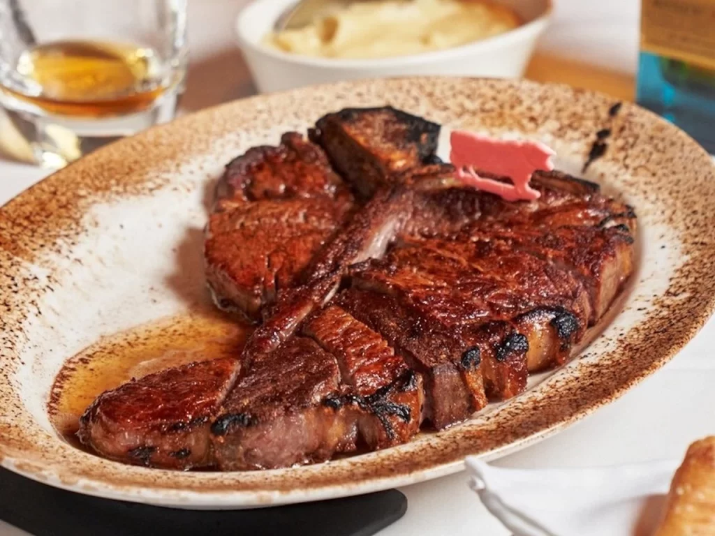 Elegant fine dining steak platter at Wolfgang’s Boracay Newcoast with ocean view.