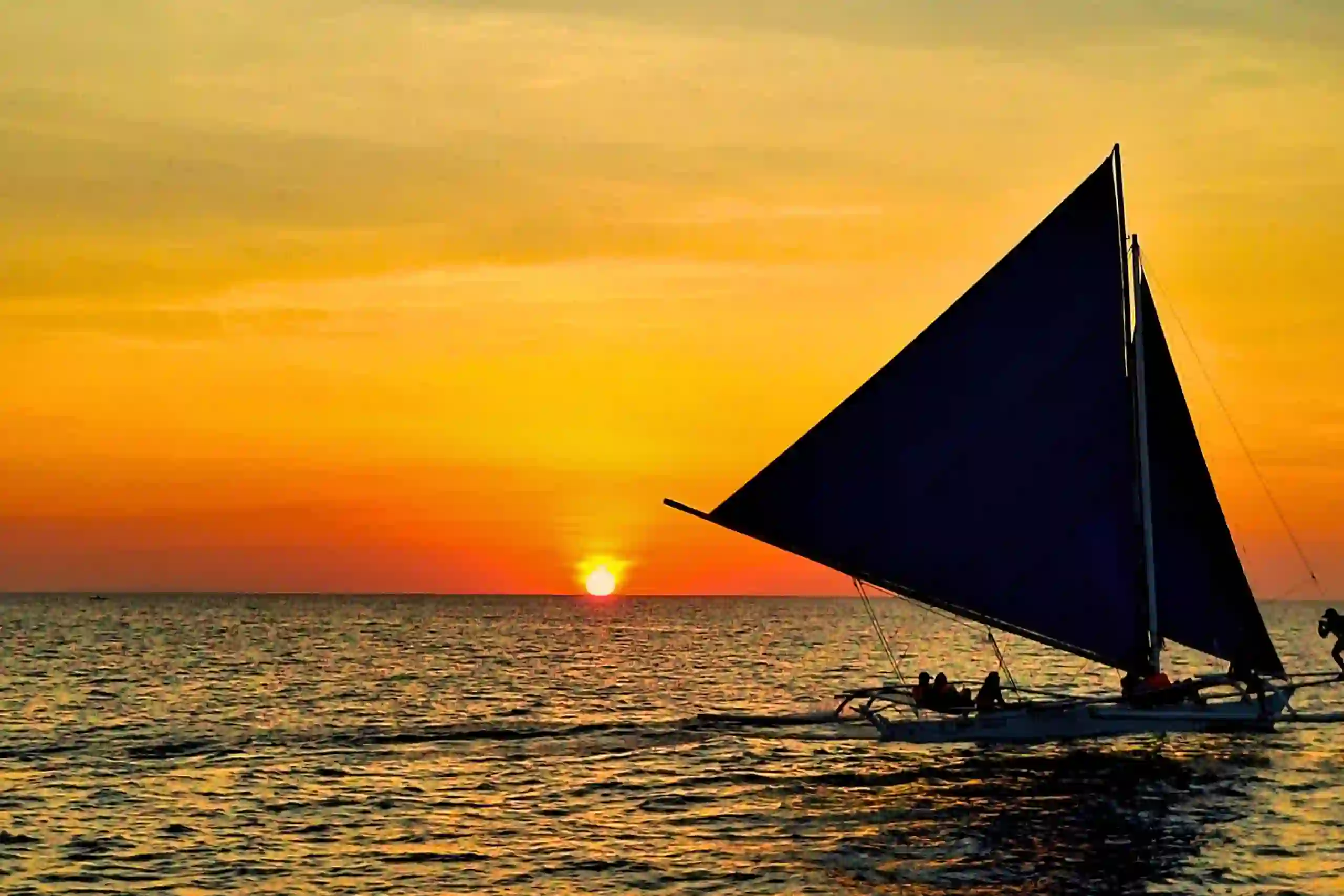 Traditional paraw outrigger sailboat at sunset Boracay